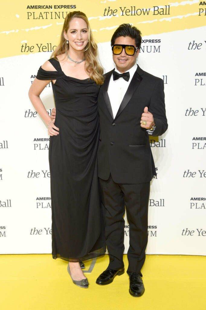 Priscilla Lynch-Hugo and Chad Hugo pose on the Yellow carpet at the Yellow Ball